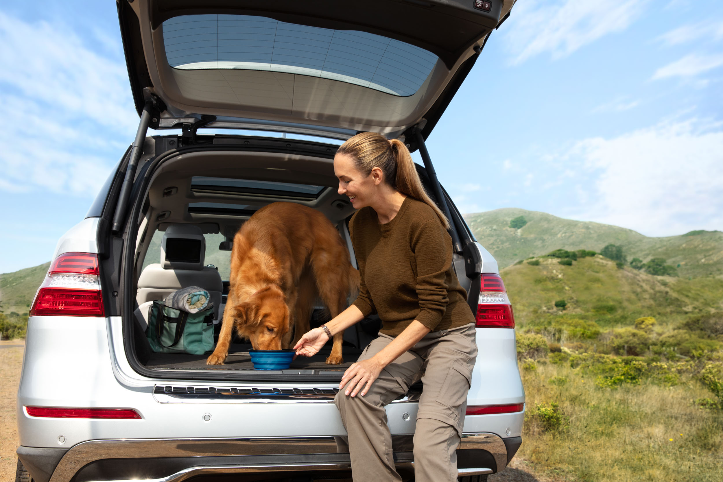 People and Pet Photography | Woman Feeding Dog in SUV by Mark Rogers