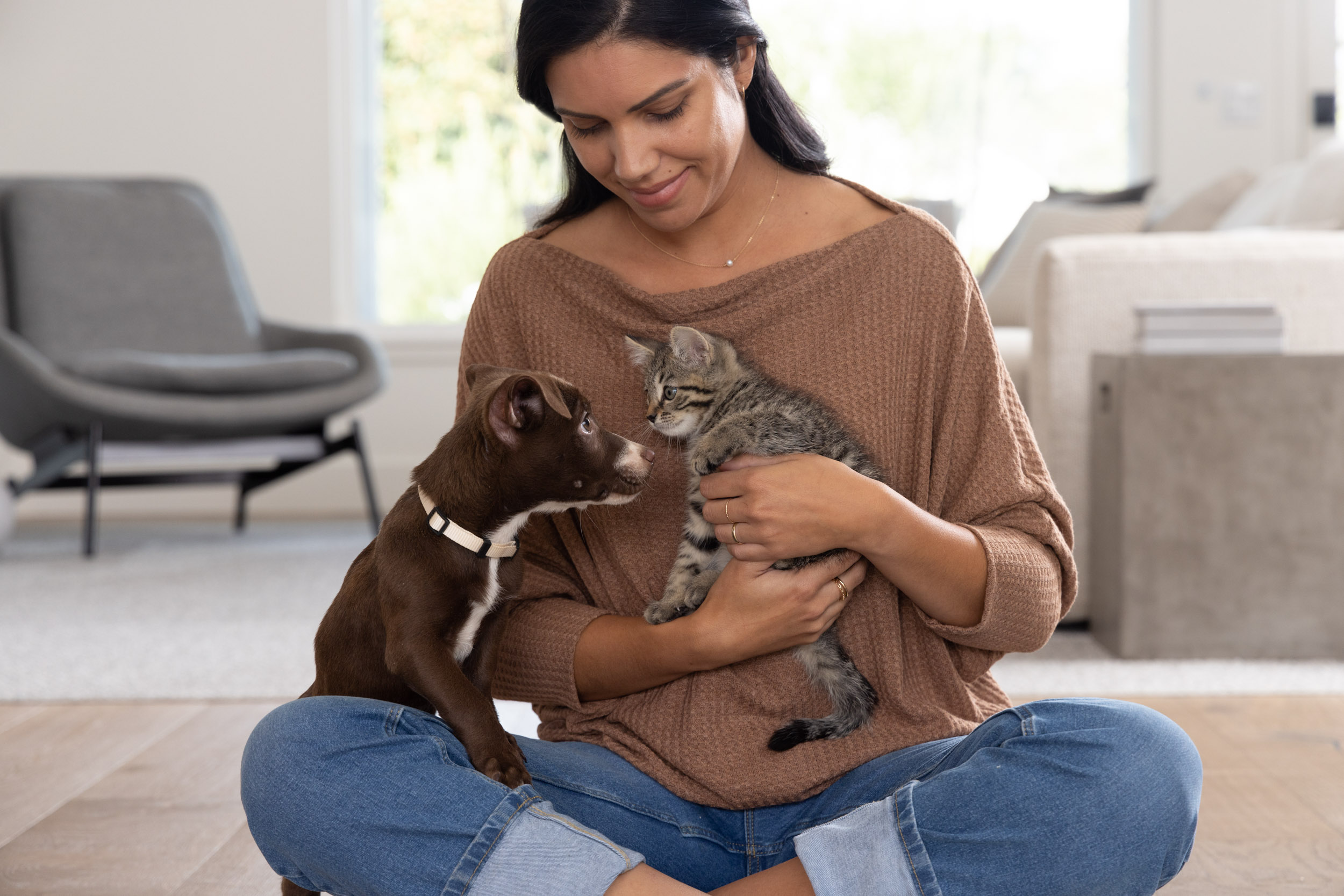 Pet Lifestyle Photography | Woman Holding Puppy and Kitten 